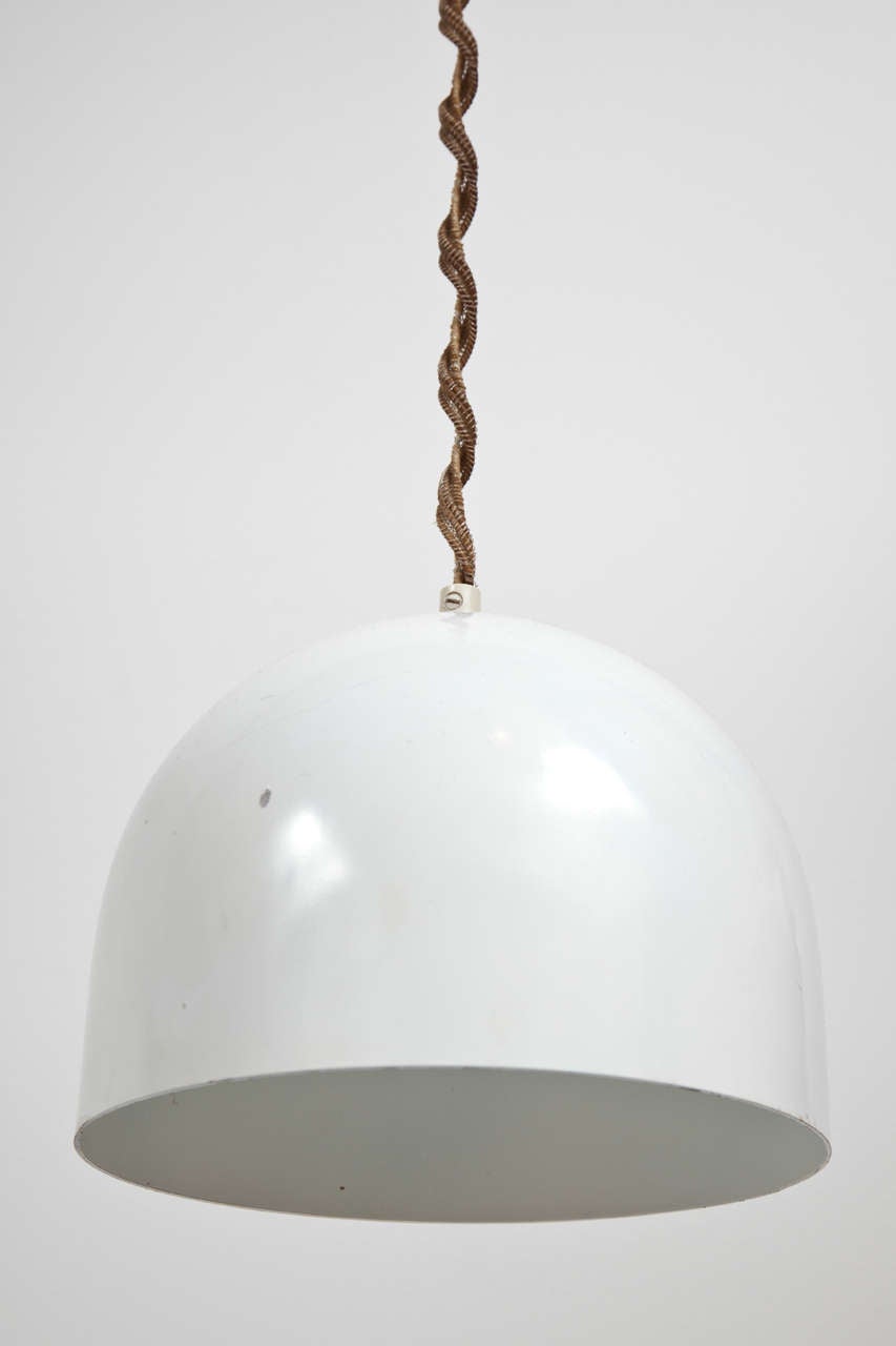 White helmet-shaped pendant light fixture with original twisted silk hanging cord and matching canopy.  Italy, circa 1960.  Wired for U.S.; takes a standard bulb, 75 watts max.

Dimensions of shade: 8 inches W x 6.5