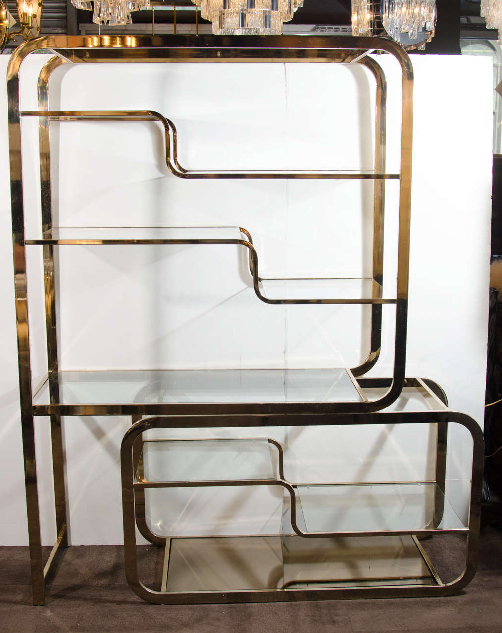 Modular design with extendable tier and bronze mirrored and glass shelves.
Width extends from 48.5