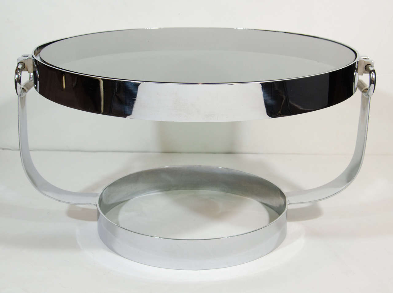Vintage circular coffee table or side table in polished chrome steel with smoked grey glass top.  The table features a round base with 