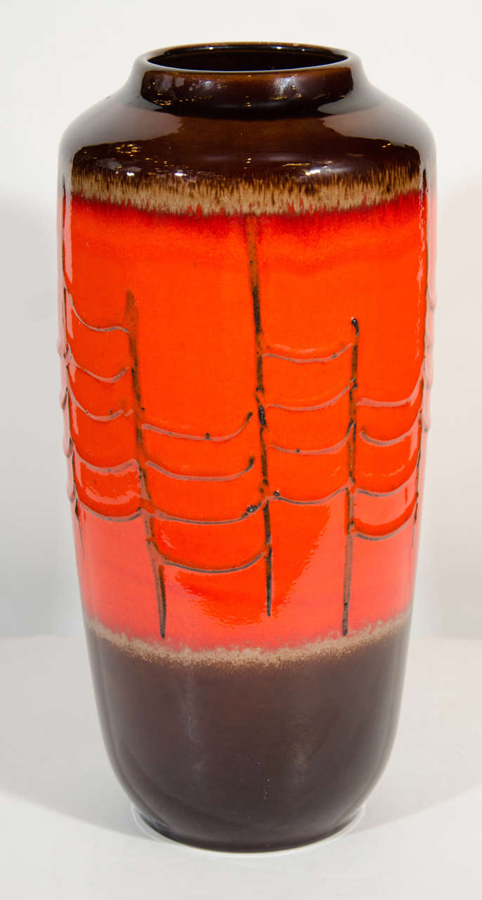 Vibrant Mid-Century Modern pottery vase by Scheurich Keramik in ceramic glazed lava. The vase has a substantial size and has beautiful hues of Vermillion orange, brown and sand. Modernist and timeless form, signed 517 45 W GERMANY on underside.