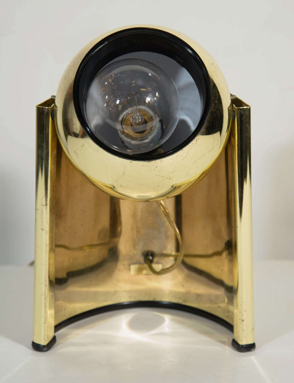 Pair of vintage orb spot lights in polished brass banded frames with black acrylic resin fittings. The lamps have curved orbital space age forms and feature adjustable spheres for preferred light direction. 