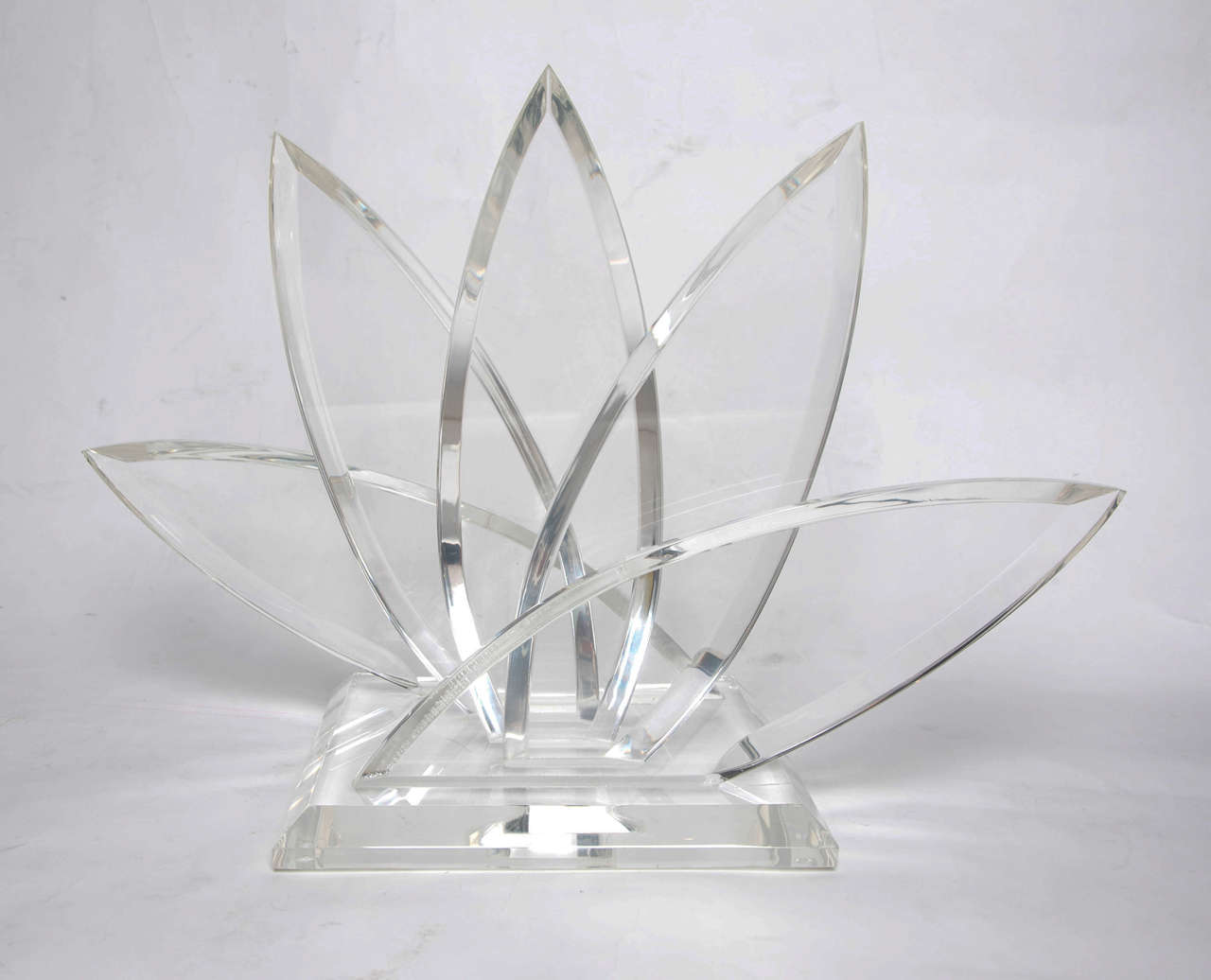 Unusual lucite letter/magazine rack made up of five large stylised palm leaves on a square base. Also proves to be an impressive sculptural piece.