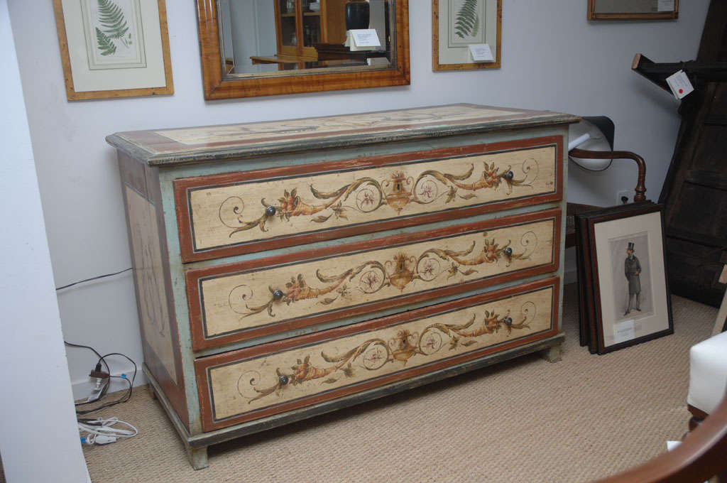 A large dramatic chest with three drawers repainted in a classical motif.