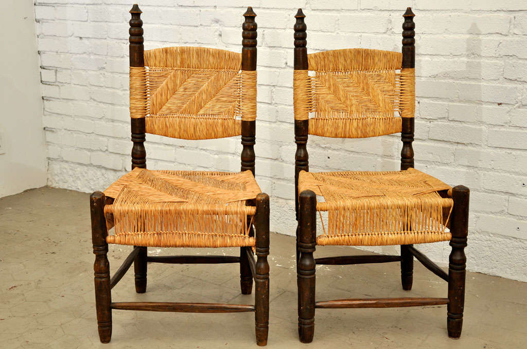 Sturdy pair of turned wood side chairs with detailed woven rattan seat and back. Price is for the pair.