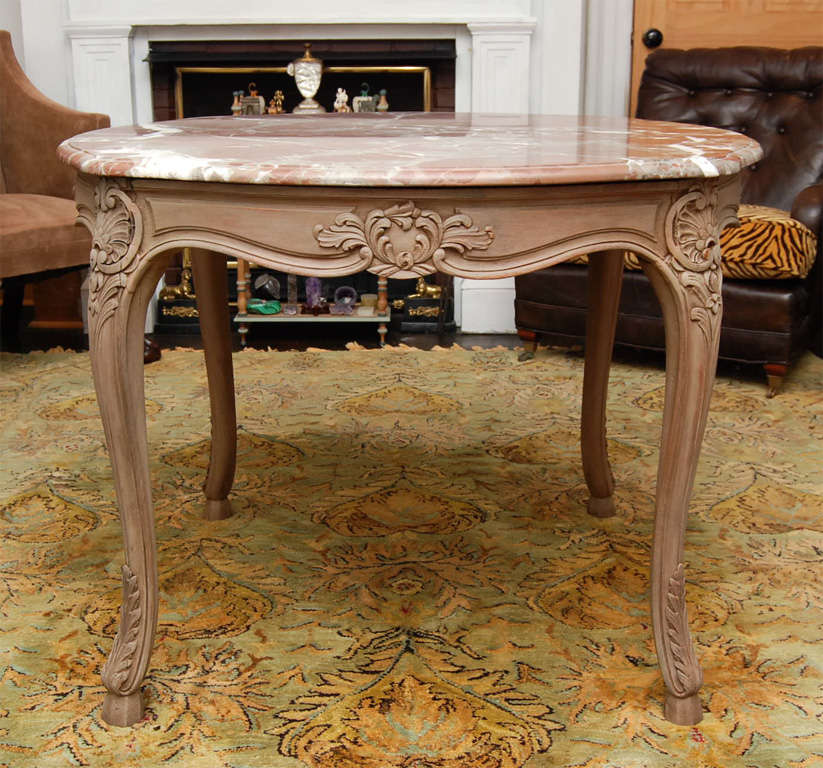 This Louis XV style table made in Italy or France in the 20's exhibits great carving and a fine fluid line. Both countries in that time period made fine furniture for export to America in exacting styles and with time-honored handcraftsmanship