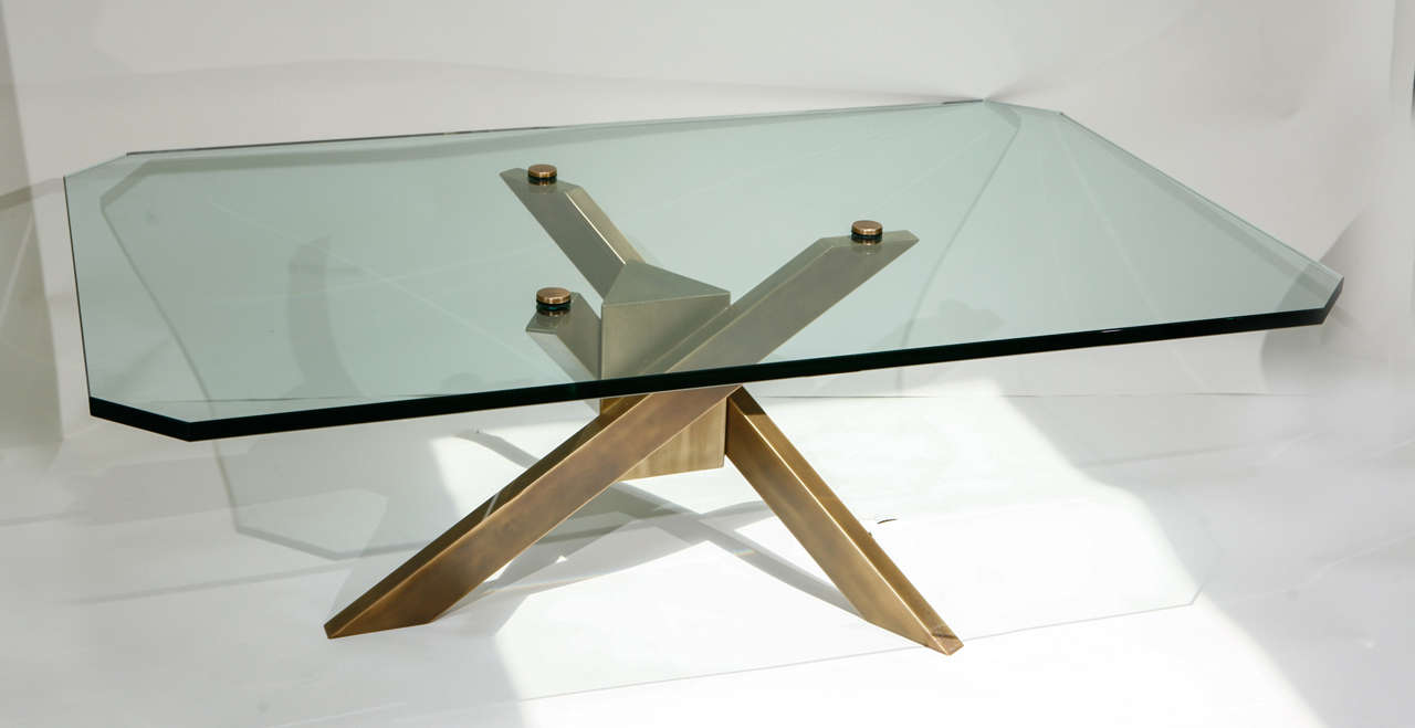 Modernistic glass coffee table with architectural base. Base in antique brass and attached to glass top with nobs. France 1950. 