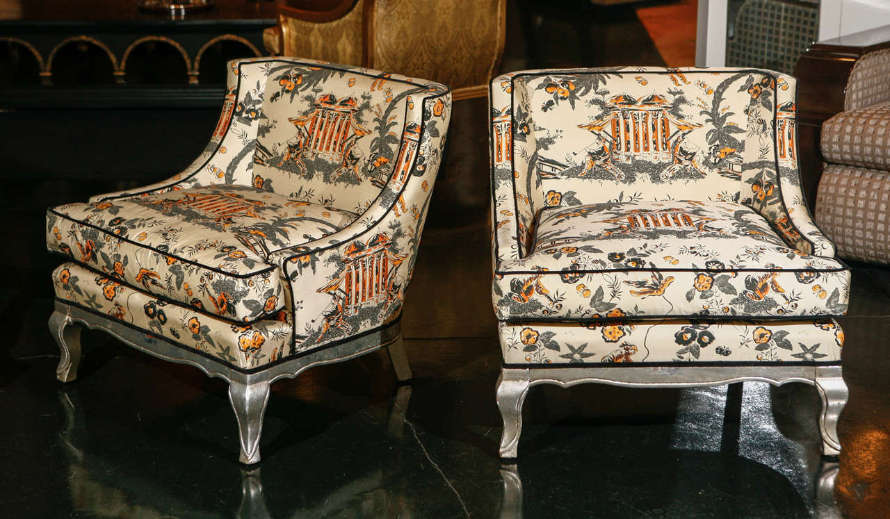 Beautiful set of salon or boudoir chairs with silver leaf base and feet. Body upholstered in silk chinoiserie fabric and velvet trim. 