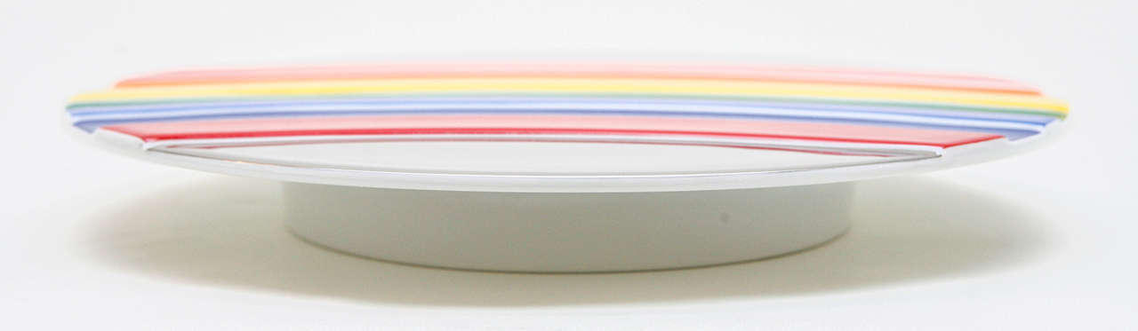 A cheerful footed plate with a textured rainbow intersecting the metallic glaze at the top and bottom. From a numbered edition by Otto Piene for Rosenthal Jahresteller, this plate is marked on the underside (see Image 8) and is numbered 840/3000. 