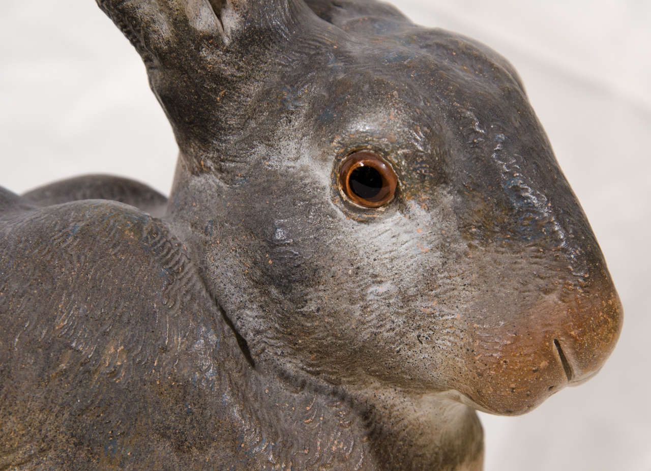 A life size 19th century rabbit realistically modeled. He is alert with paws tucked under him, curled tail, and head turned to one side. 
 He has excellent detailing of his coat, long pointed ears, and expressive glass eyes. 
 A realistic terra