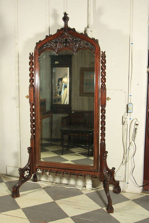 A MAGNIFICENT ROSEWOOD FLOOR STANDING  MIRROR IN THE GOTHIC REVIVAL STYLE, PIERCED WORK, TWISTED UPRIGHT SUPPORTS, GOTHIC ARCHES AND TRACERY ALL OVER