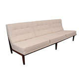 Early Florence Knoll armless quilted sofa on walnut frame