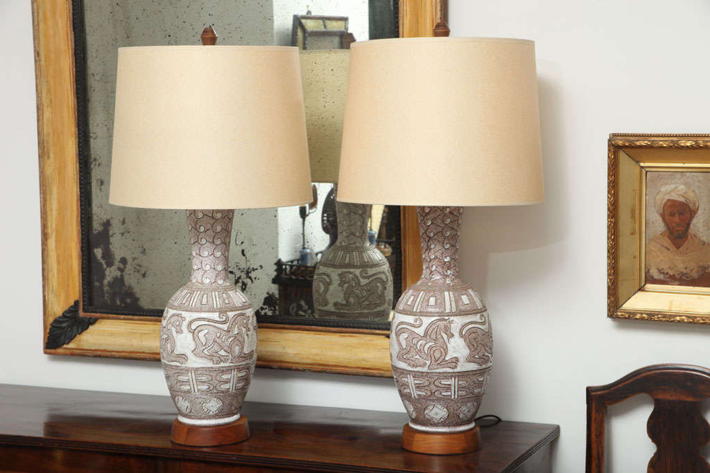 Pair of Italian ceramic white and brown glazed lamps with etched horse decorations.