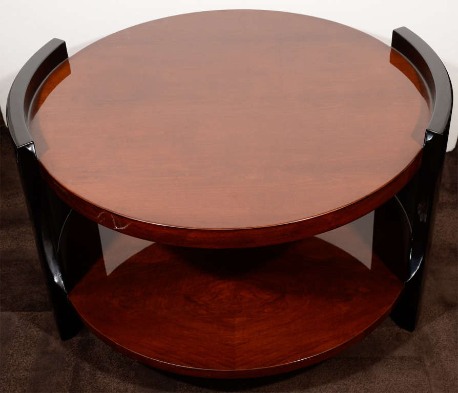 Art Deco occasional table or cocktail table
with streamline design.  Table has two tier
design with rounded legs/base details. 
In book matched walnut wood with 
black lacquered details.