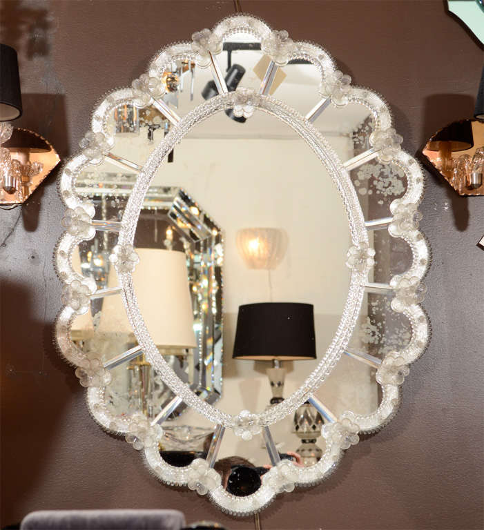 Oval Mirror contained within a 16 Panel Antique Mirrored Surround with reverse bevelled & Scalloped Edge, Rosette Accents & Hand Blown Murano Glass Appliqués