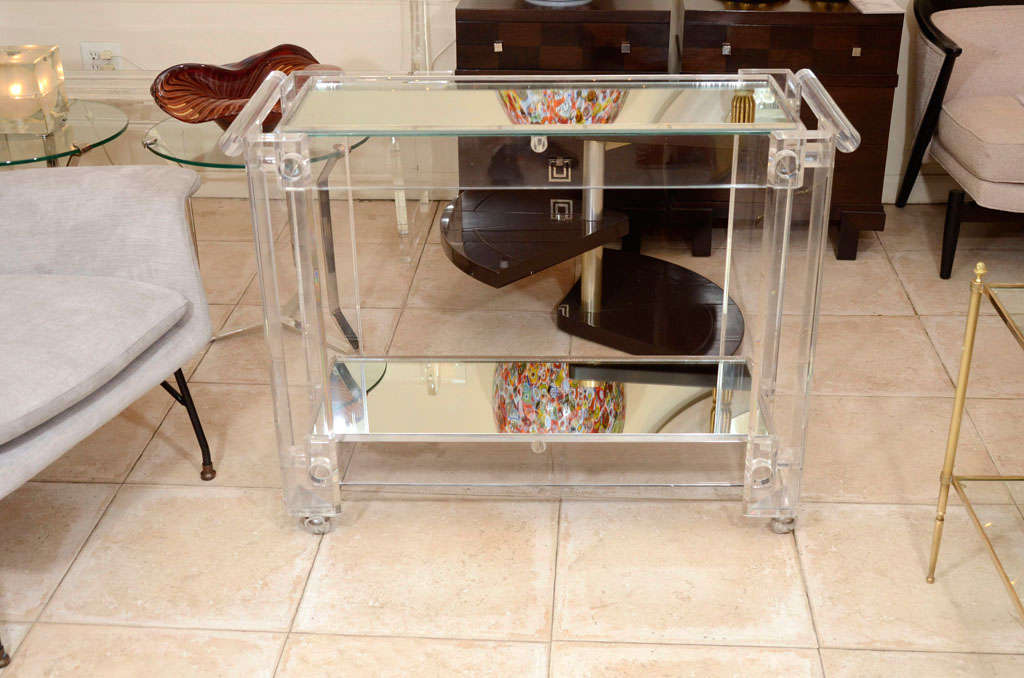 Lucite rolling cart featuring two mirrored shelves.

View our complete collection at www.johnsalibello.com
