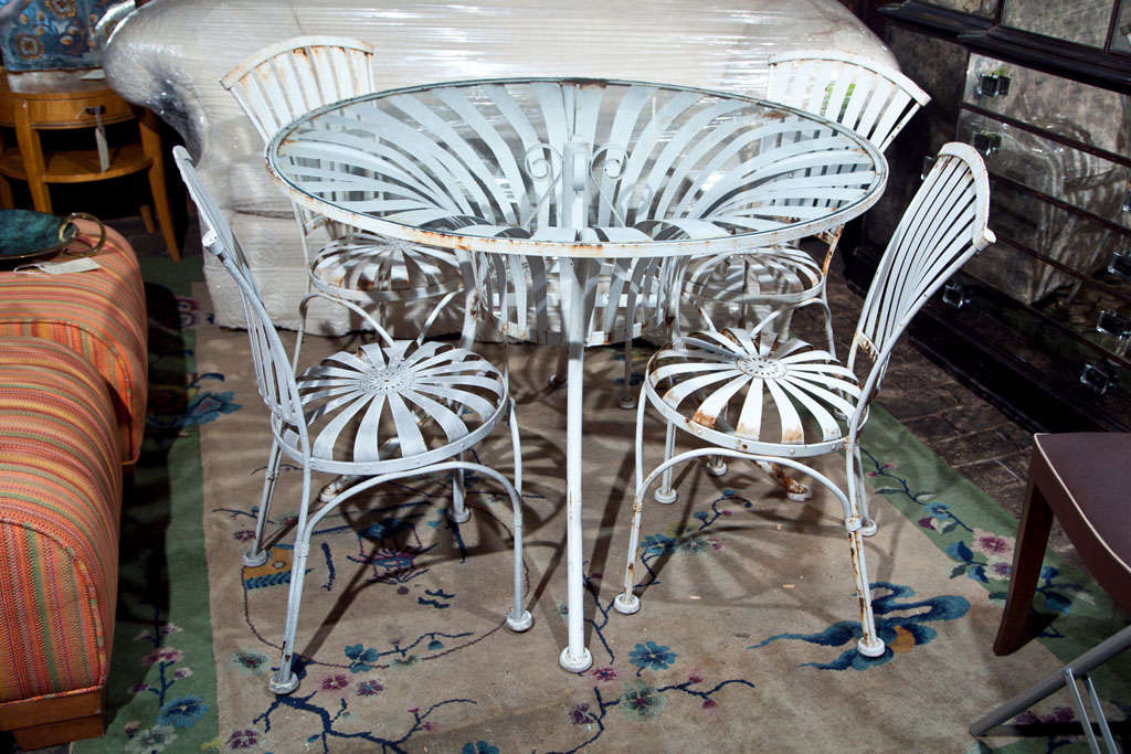 Vintage set of four Spring chairs and round table. Chairs are measure: 18 W x 21 D x 32.25 H. Seat height is 17.