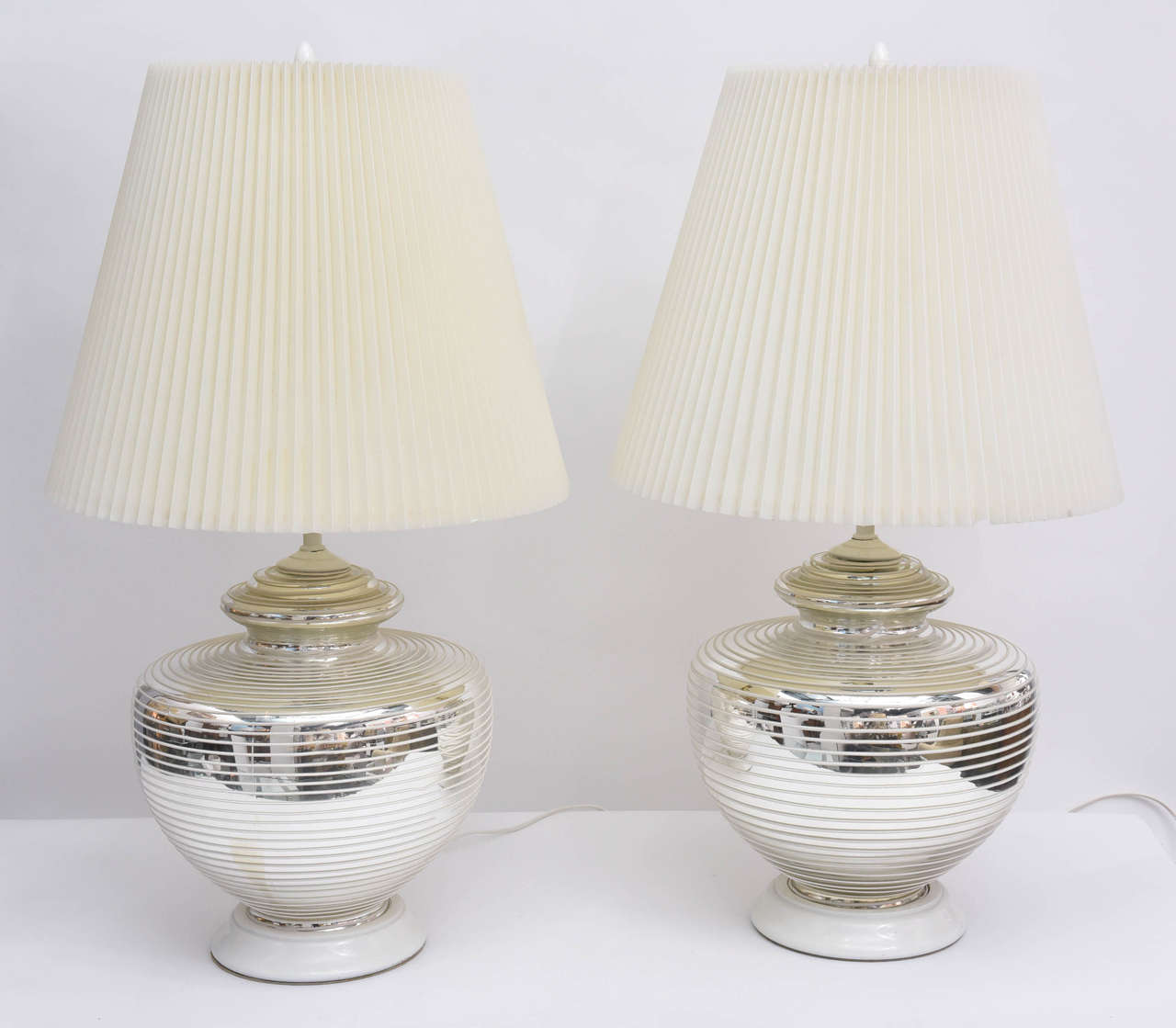 A great 1970s vintage mercury glass globes urn-style table lamps. White engraved 