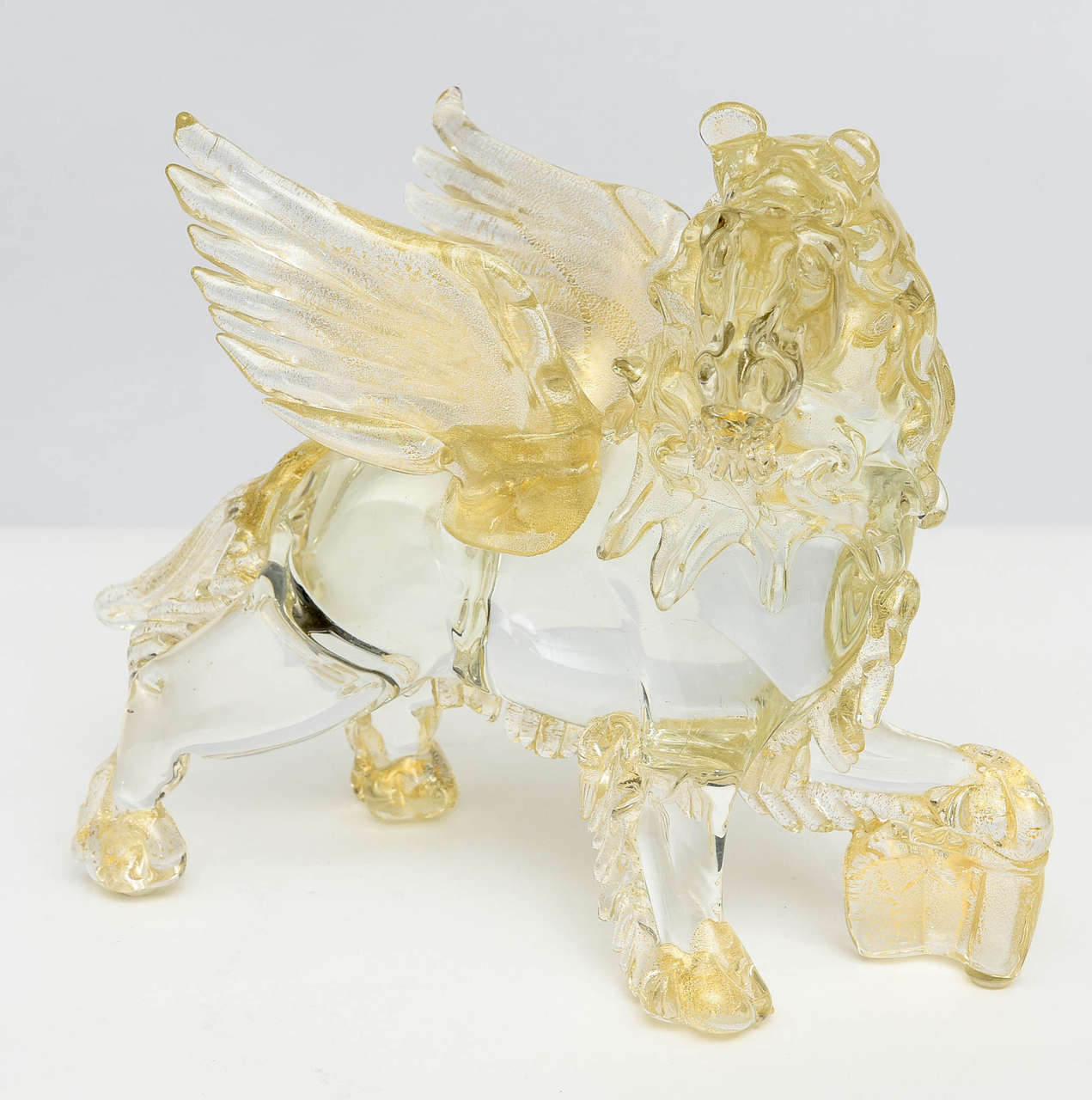 Beautiful handblown winged recumbent lion in clear glass with amber glass accents.