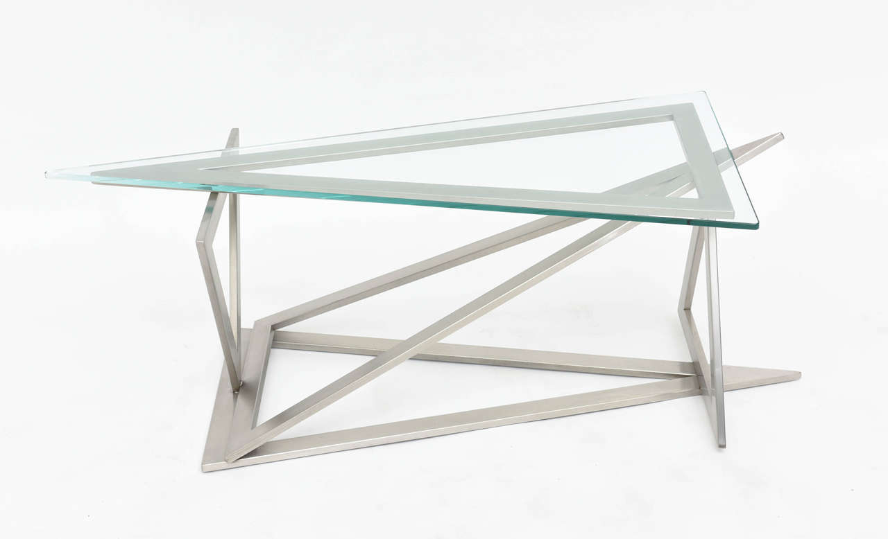The triangular glass top above a series of stainless triangles connected in a sculptural form.