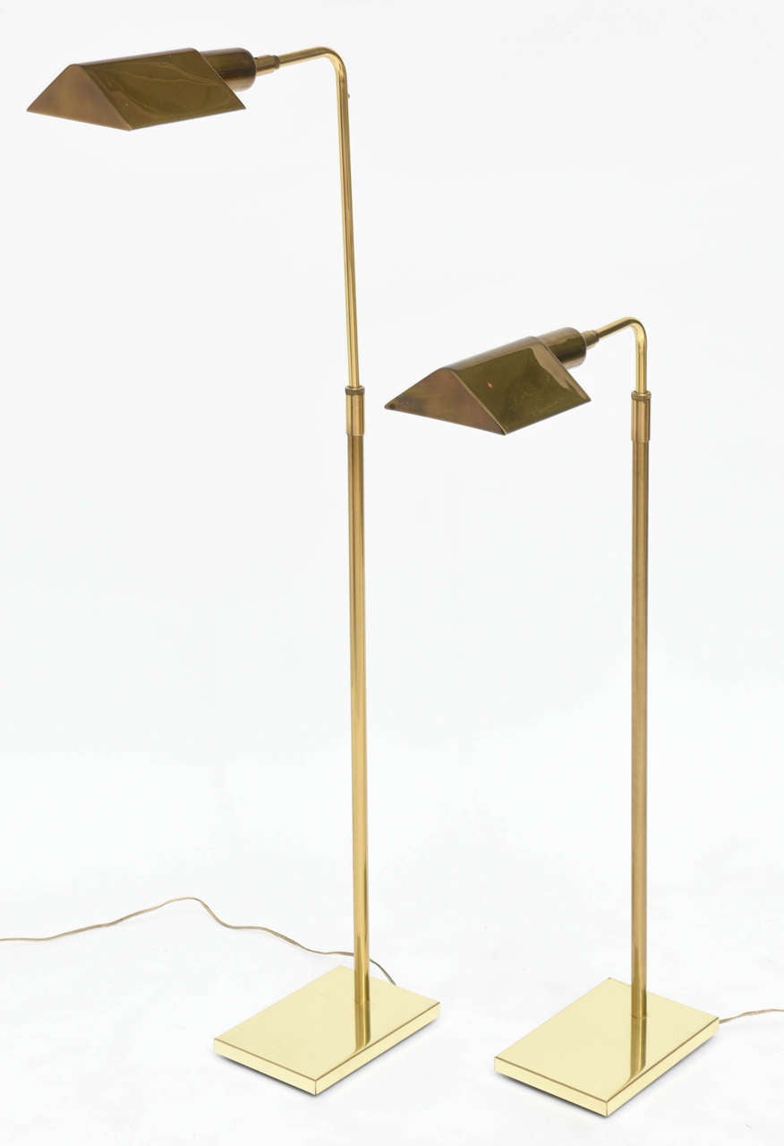 The triangular adjustable shade with an adjustable pole on a rectangular weighted base.
