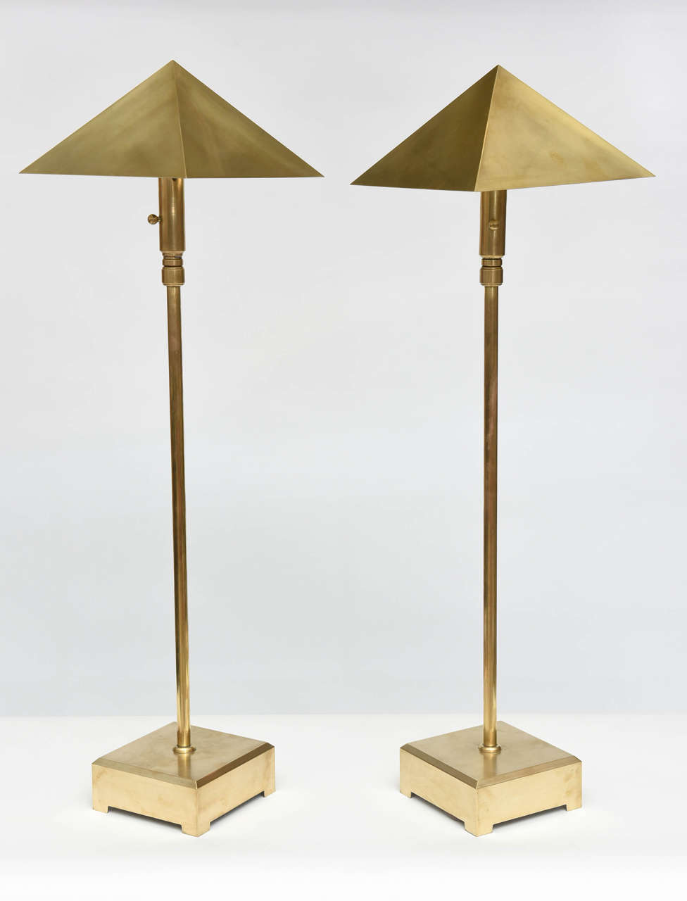 The pyramidal shade above an adjustable pole to extend or shorten the overall length, on a square plinth with bracket feet 40.5 without extension, extents to 64