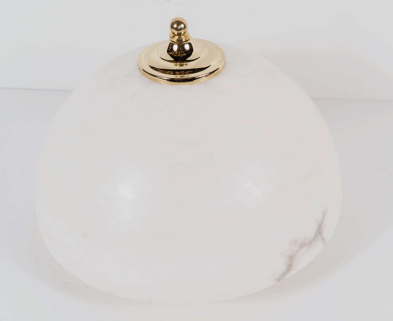 Elegant Art Deco alabaster dome flush mount with brass fittings tipped with a brass ball detail. The alabaster is fairly consistent throughout with light veining which is enhanced when lit. This piece has been newly rewired and takes three