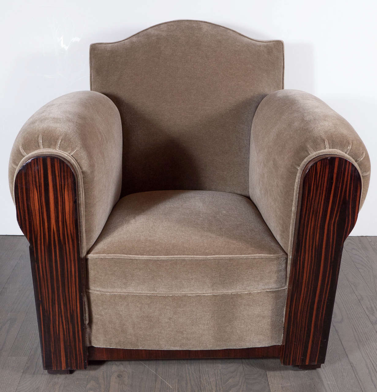 These gorgeous chairs feature bookmatched Macassar wrapped sides, base and arm front details. They have been newly upholstered in a deep tobacco mohair fabric. They are a Classic Art Deco club chair design with rolled arms and a scrolled design