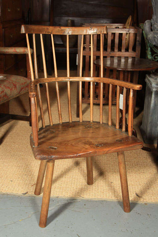 A primitive ash comb-back Windsor chair from West Country England.