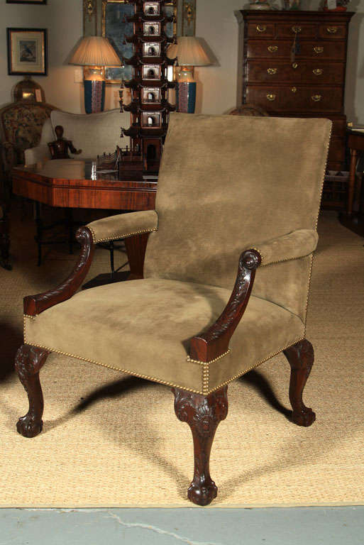 Handsome George III style handcarved mahogany English library chair with new leather upholstery and brass nailhead trim.  Sold by French & Co., NY