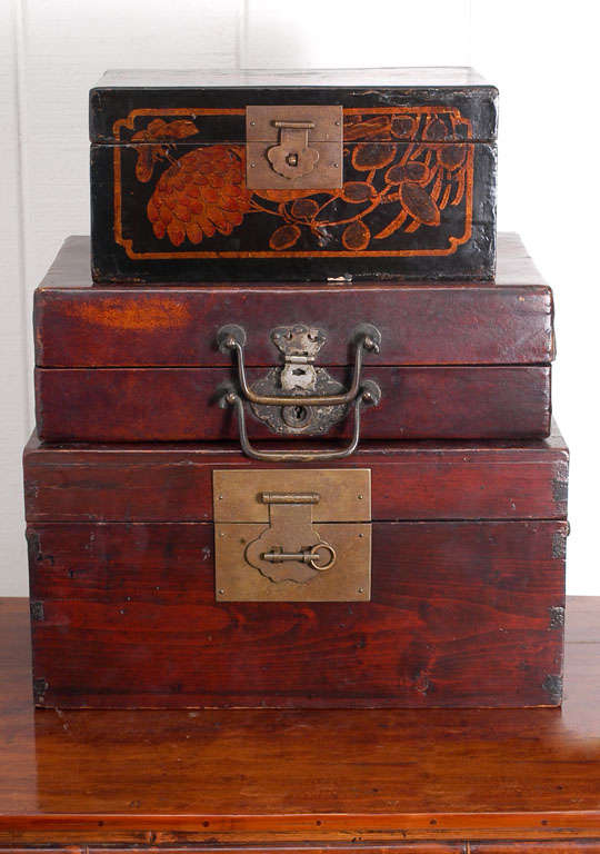 Group of decorative document boxes from 19th century China. Bottom box is elmwood, the middle is oxblood colored leather, and the top is an exquisite polychrome lacquer.