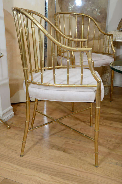 Brass Pair of upholstered brass faux bamboo arm chairs