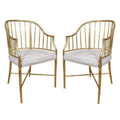 Pair of upholstered brass faux bamboo arm chairs