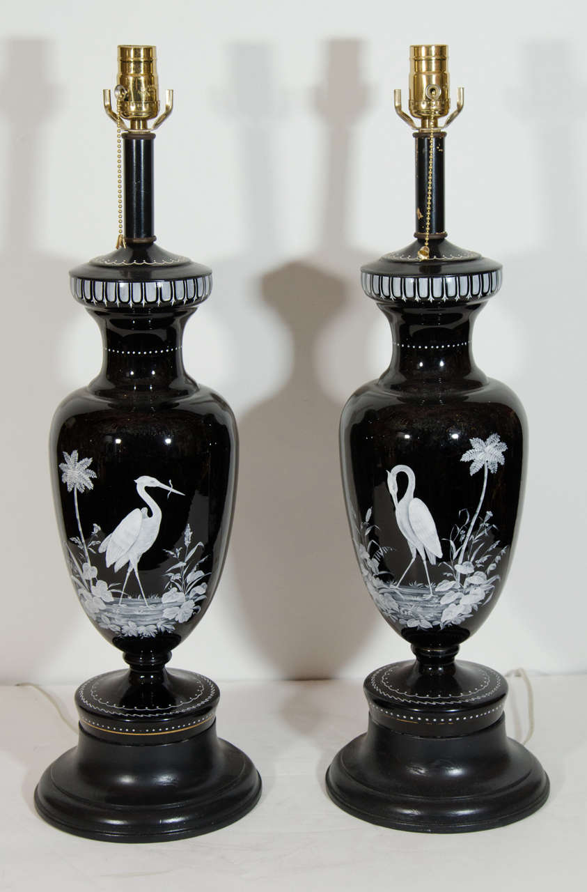 A Pair of Large Unique Antique French Louis XVI hand painted white enameled black glass vase/lamps of exquisite craftsmanship attributed to Baccarat. This pair of unusual black glass lamps are hand painted with raised white enamel depicting scenes