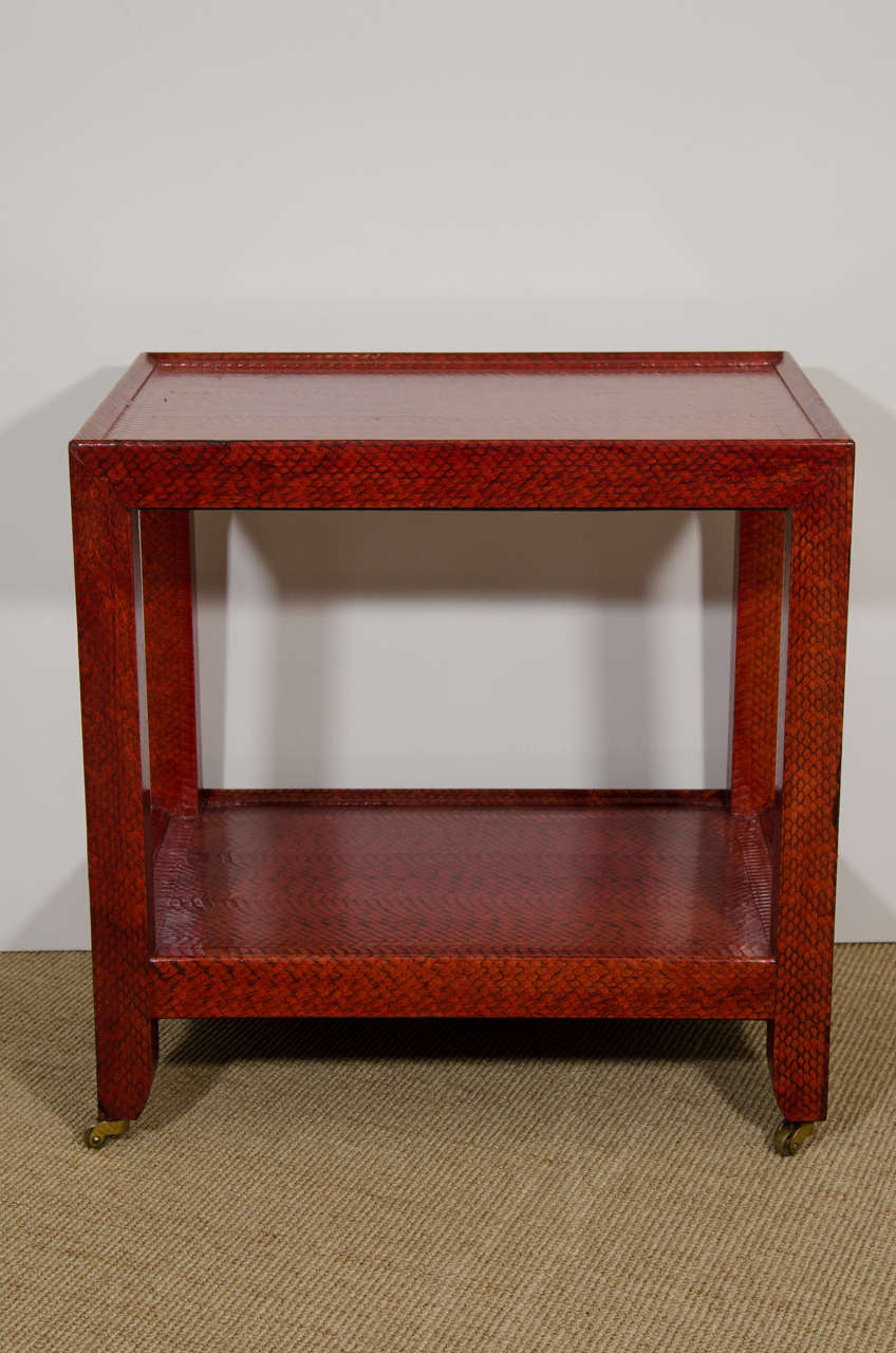 Karl Springer red snakeskin telephone table on castors, label on underside.
