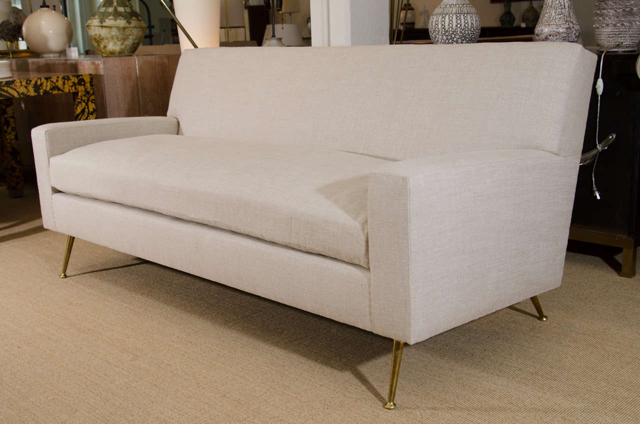 Custom order Robsjohn Gibbings sofa with brass legs, circa 1950s, reupholstered in 100% Belgian linen.