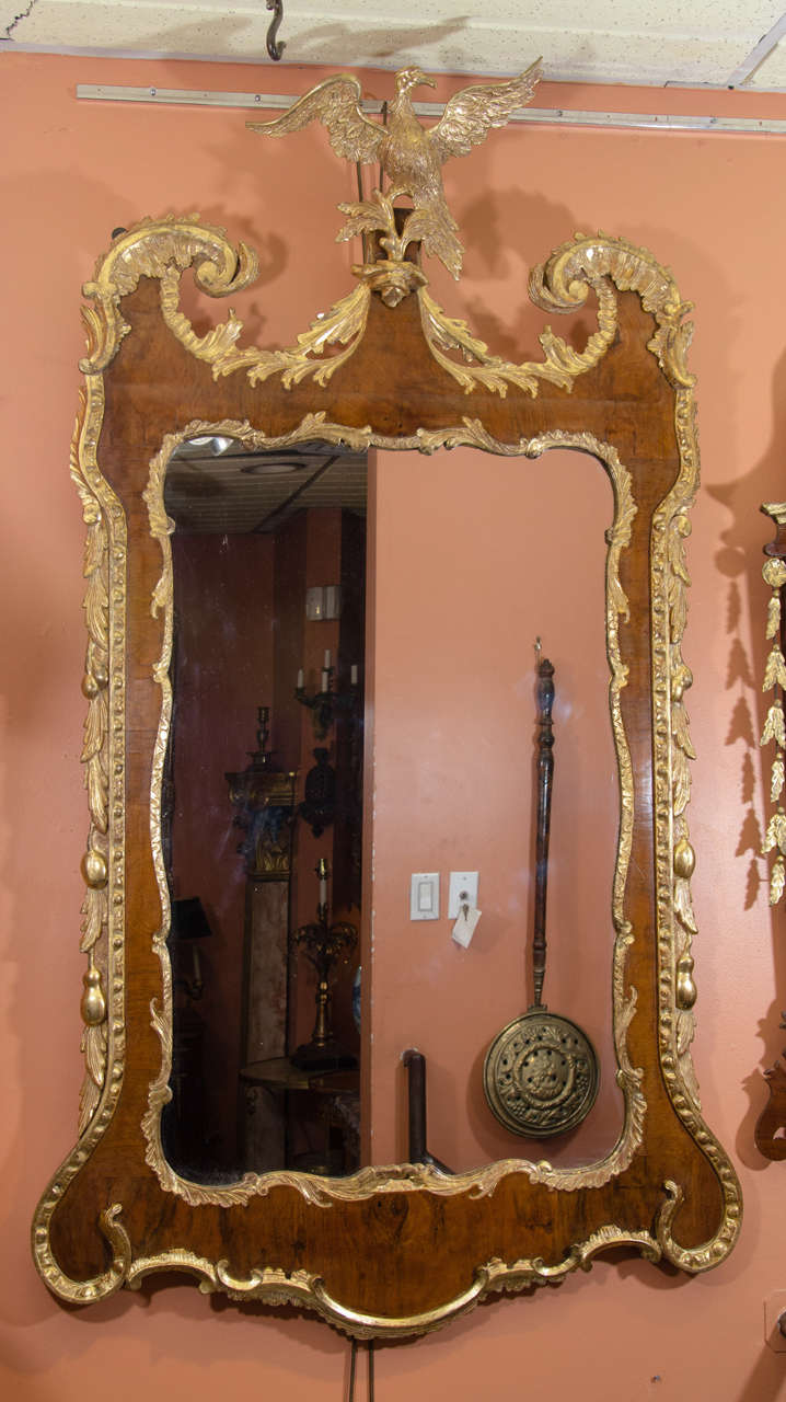 A fine large George II carved walnut and gilt scroll top mirror with eagle surmount.
