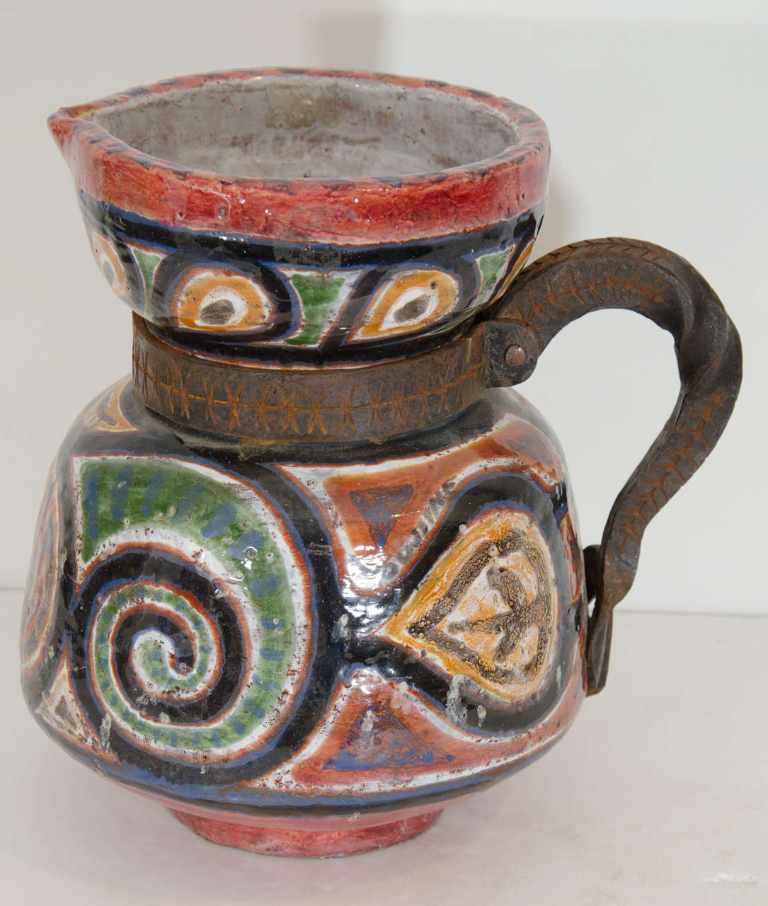 Iron handled ceramic vase.