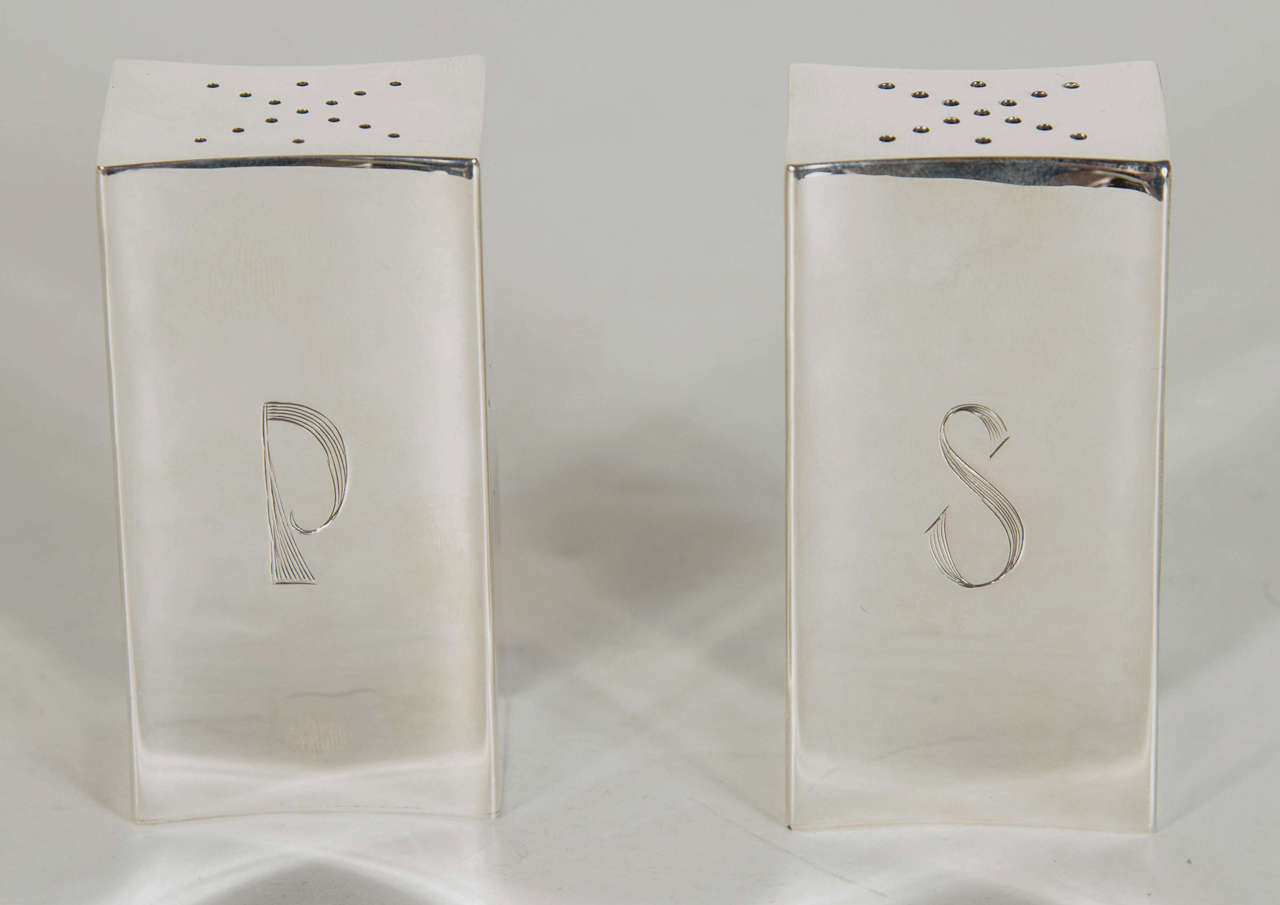 These rare and exquisite shakers feature a bowed modernist convex design and are hand made in Sterling silver by the House of Allan Adler known for its stunning custom and modernist designs.They are both signed Allan Adler Sterling on the