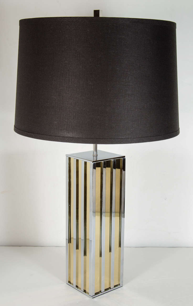 These stunning lamps feature a modernist streamline design of bands of polished nickel and brass.They have been completely rewired and also fitted for two bulbs . They also have custom shades as well.