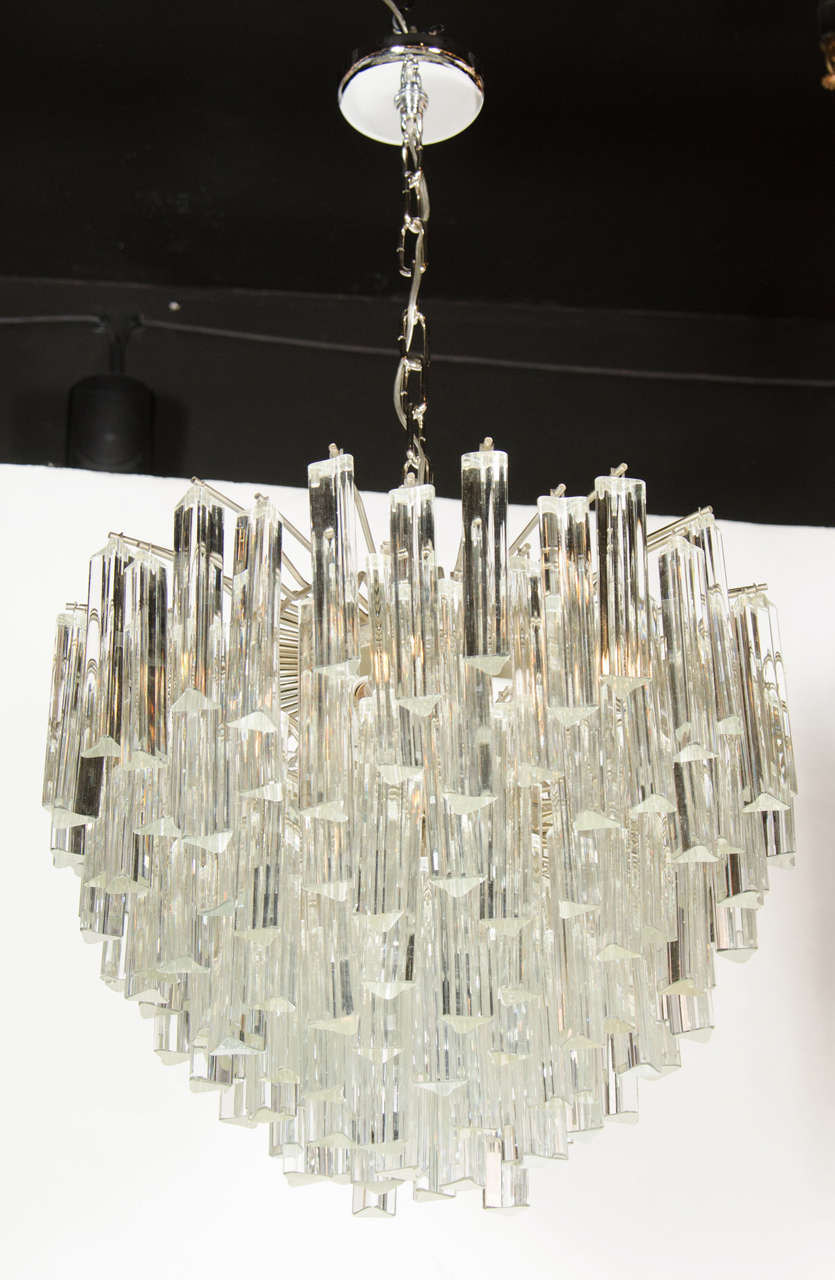 This exceptional Mid-Century Modern chandelier by Camer features individual hand made Murano glass triedre prism rods hung from a nickel frame in a cascading effect. The high quality glass reflects the light beautifully and has an elegant shape. It