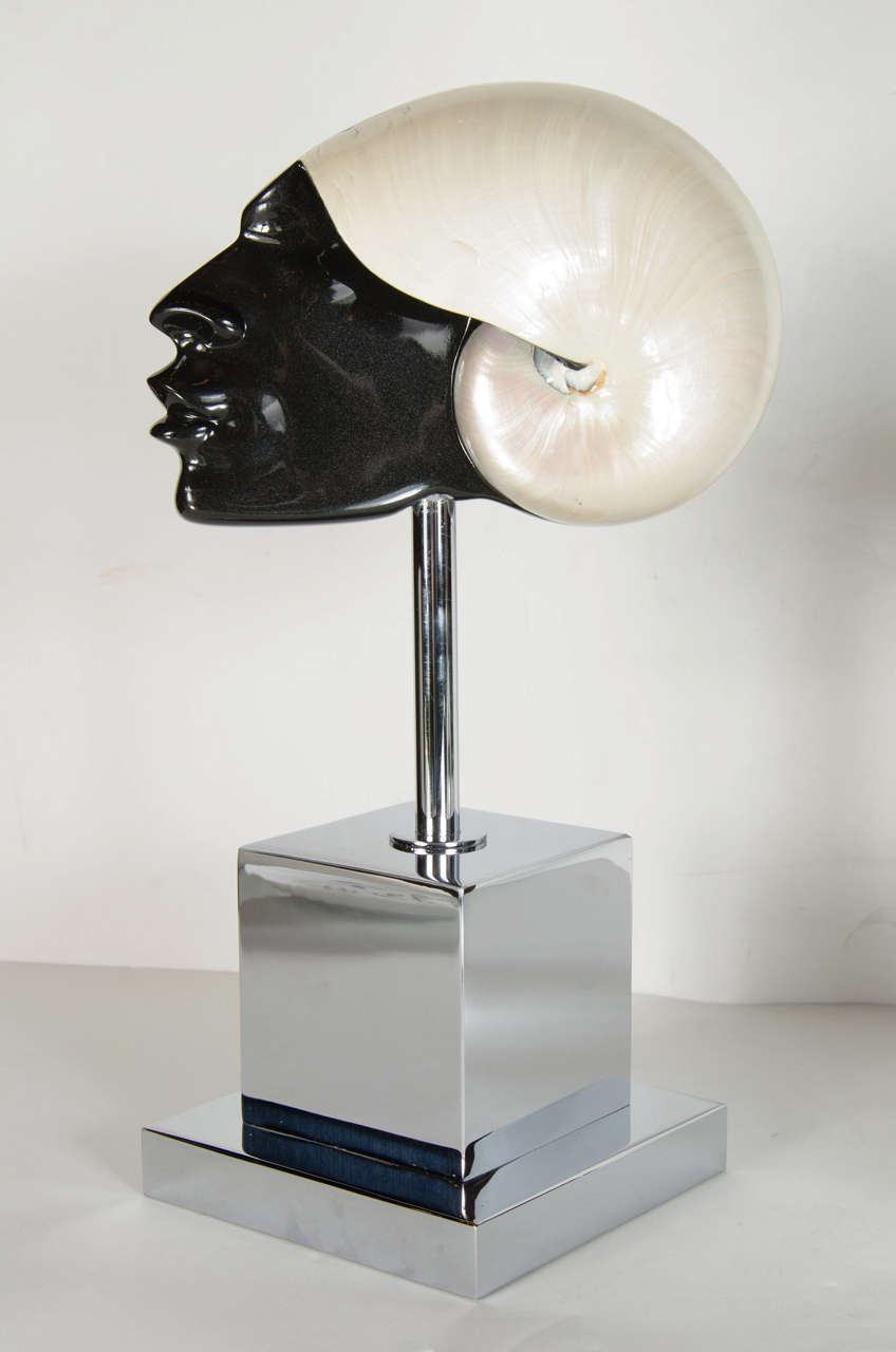 This stunning Black-a-Moor is a man depicted with a turban out of a carved nautilus shell with an lacquered face mounted on a custom nickeled stand. This piece was purchased from the Lorin Marsh showroom in the 1970s and still bears the original