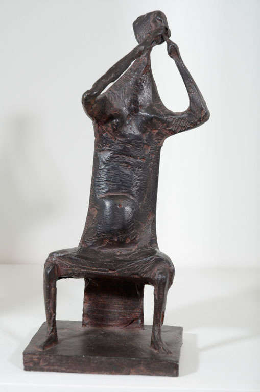 Abstract bronze sculpture of seated female musician.