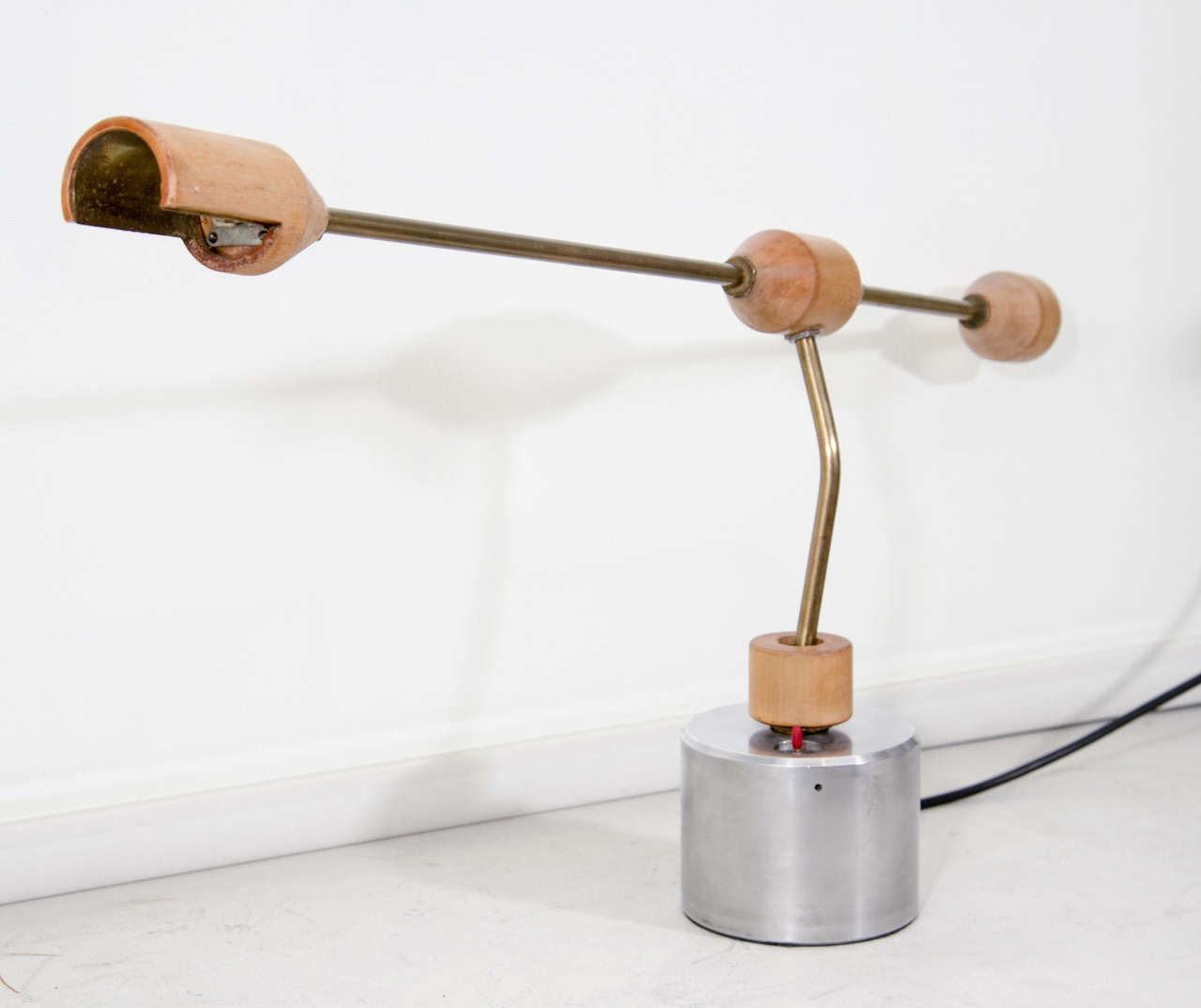An Italian wood and steel table lamp, 1970s, articulated one arm desk light.
     