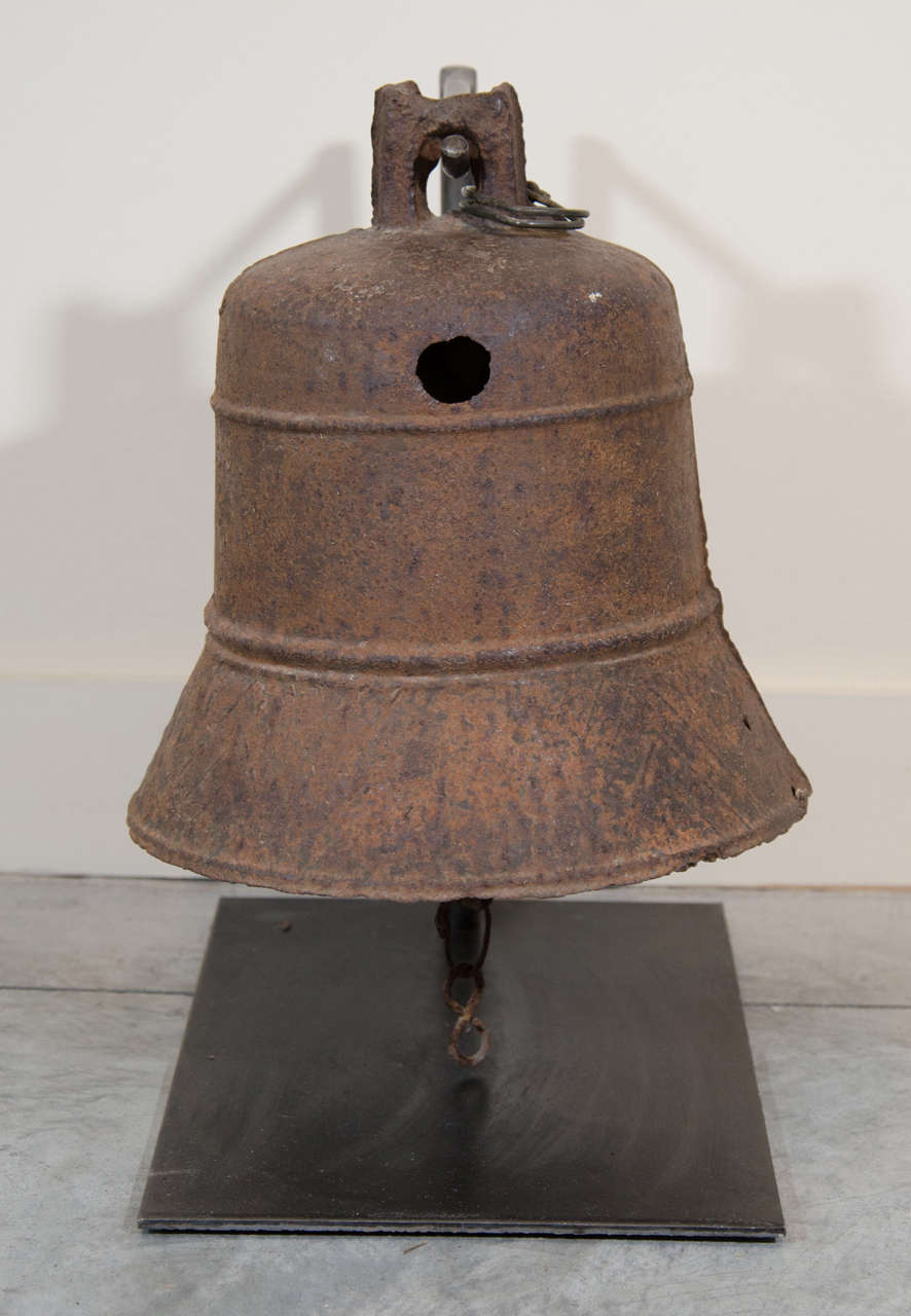 Eine gusseiserne Tempelglocke aus dem frühen 19. Jahrhundert mit zwei ausgeprägten horizontalen Bändern. Inklusive individuellem Eisenständer. Aus China, Provinz Shanxi, um 1820.<br />
M903