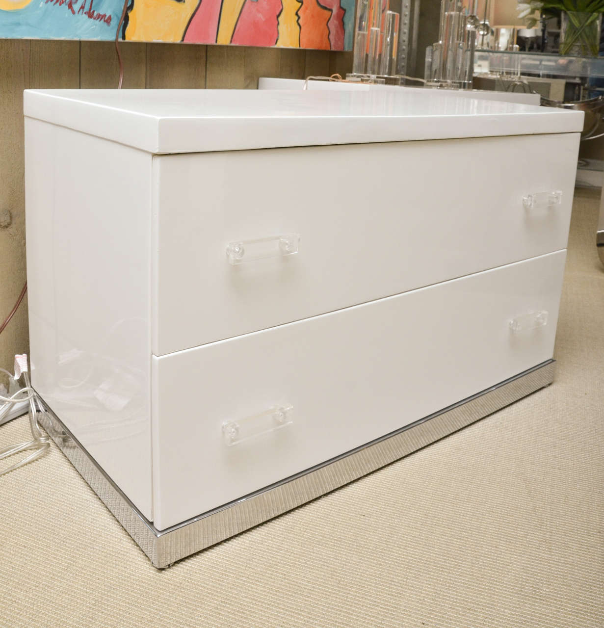 Attractive pair of white lacquer 2-drawer nite stands. The nite stands have chrome bases and Lucite draw pulls