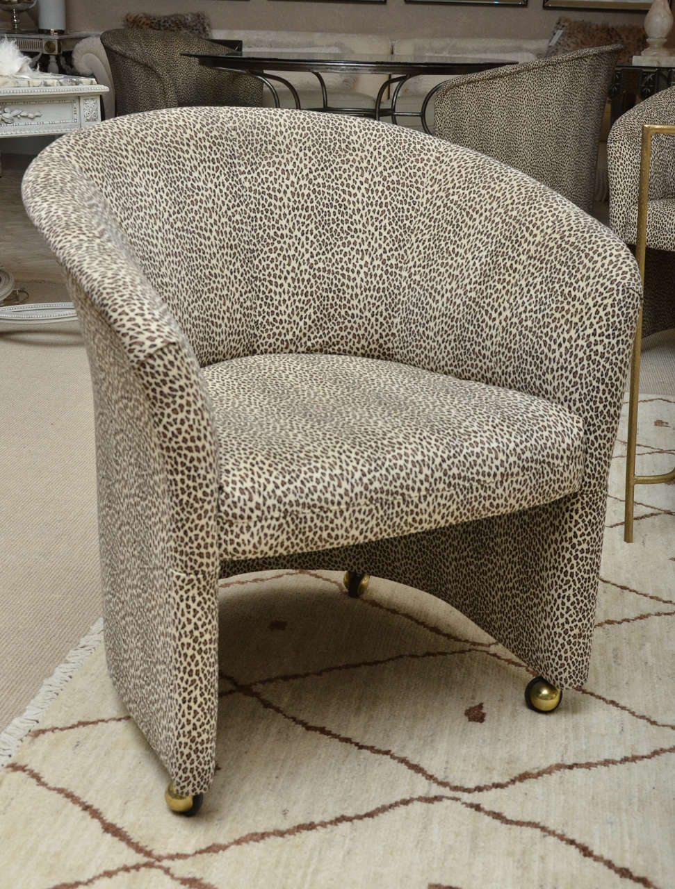 Attractive set of 4 baby leopard suede barrel back arm chairs on casters.