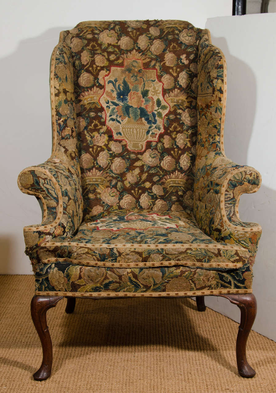 With fine needlepoint upholstery depicting flowers, pelmets, crowns surrounding a central vase with flowers. On cabriole front legs with carved ring around the back.