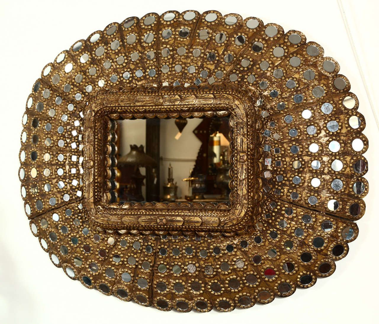 Large scale Moorish gilt wood peacock mirror.
Impressive Hispano Moresque large scale hand-carved gilt wood inset with a multitude of small mirrors.
Could be hang both ways.