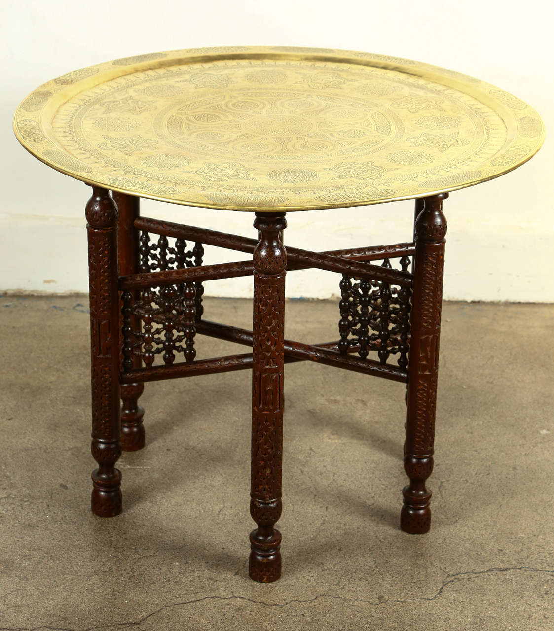 Antique Mameluke Brass Tray on Folding Stand.
Amazing hand chiseled brass tray table, very fine intricate work on brass, sit on an antique wooden base carved and inlaid with mother of pearl and intricate fret work.
Very decorative large and heavy