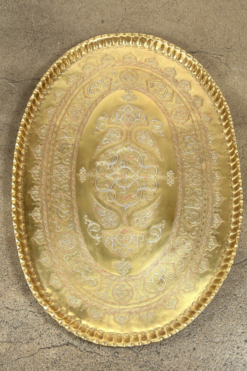 Antique huge oval Islamic Arabic Calligraphy tray inlaid with silver and copper.
Very rare to find, antique 19th century Persian brass tray inlaid with silver and copper Islamic Calligraphy writing and foliates patterns.
This Middle Eastern